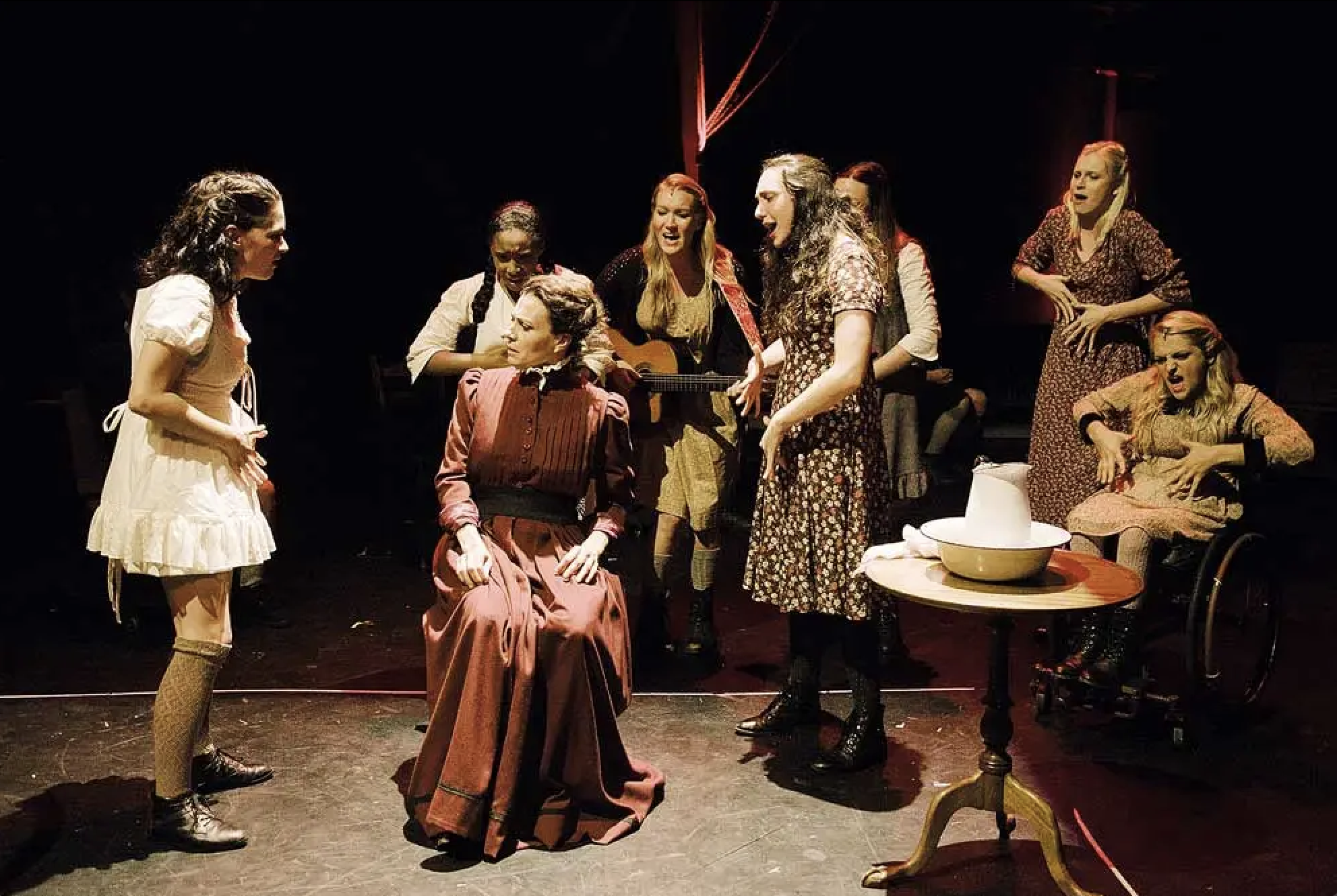 Sandra Mae Frank, Treshelle Edmond, Natcha Roi (seated), Katie Boeck (on guitar), Lauren Patten, Amelia Hensley (obscured), Alexandra Winter, and Ali Stroker in “Spring Awakening” at Deaf West Theatre in 2014. (Photo by Tate Tuller)