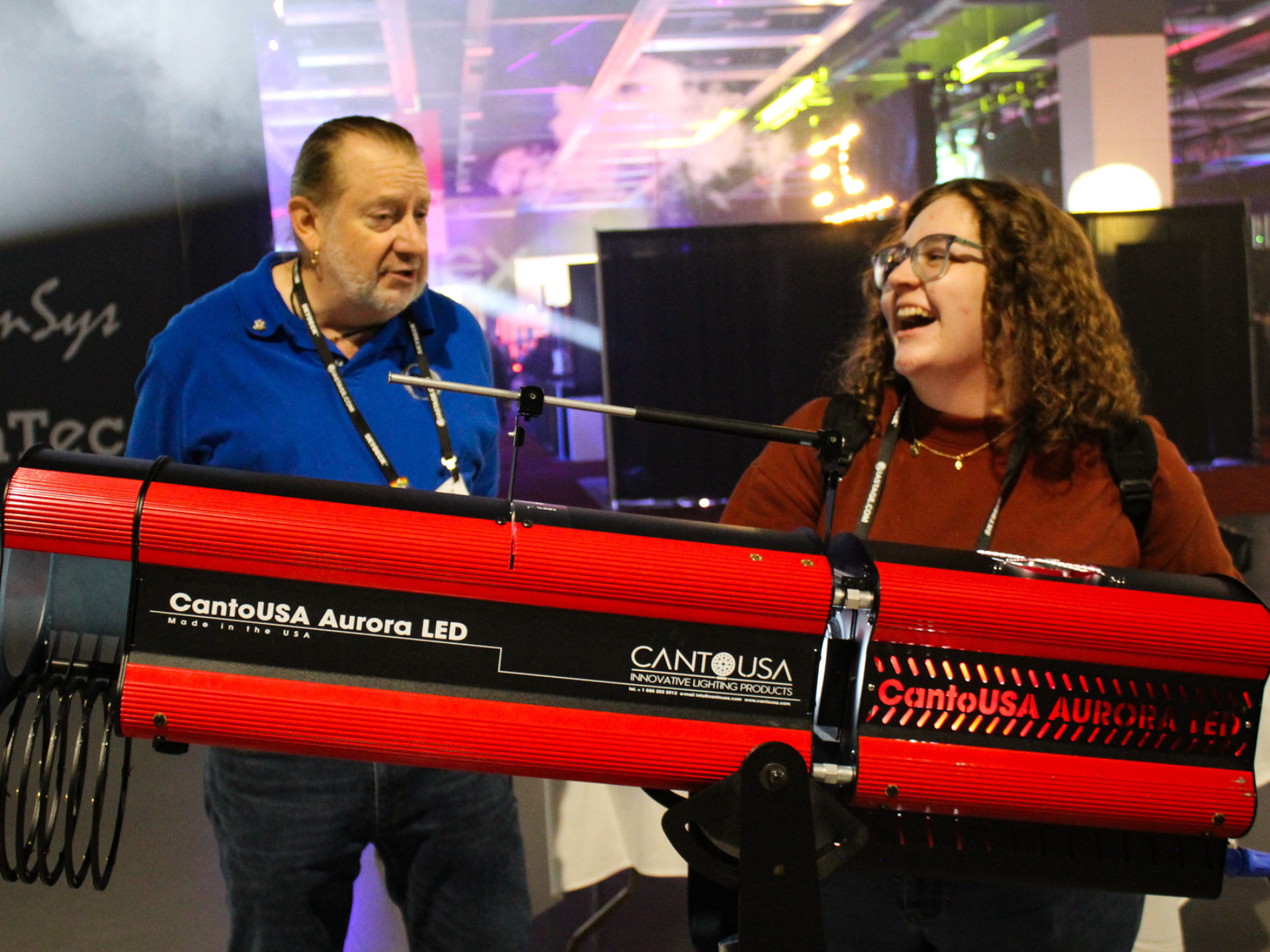 An Exhibitor leads an attendee in a hands-on experience with a spotlight