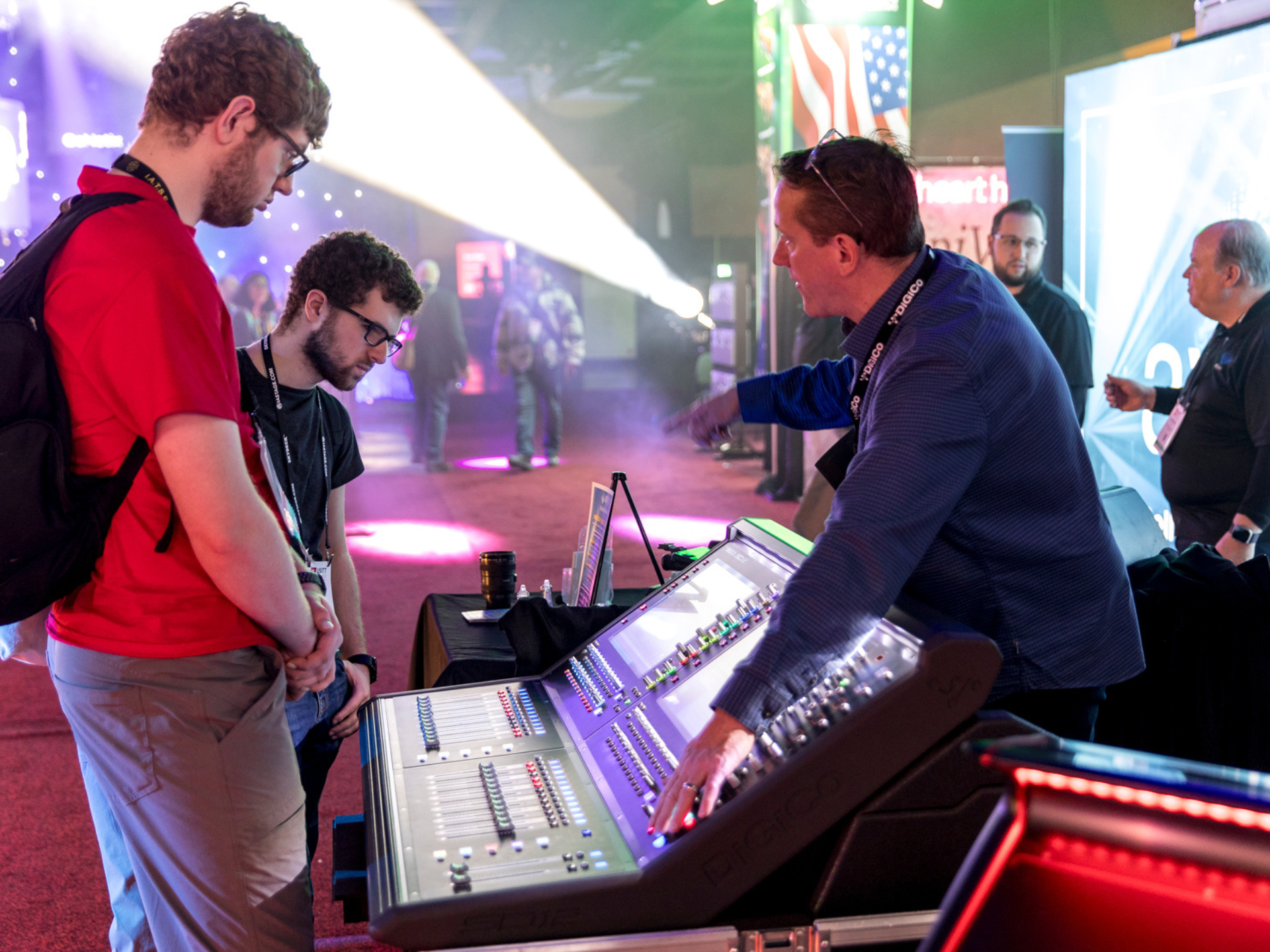 An Exhibitor showcases products to two attendees